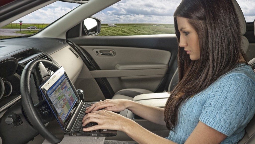 Craziest things people do while driving-typing-on-laptop